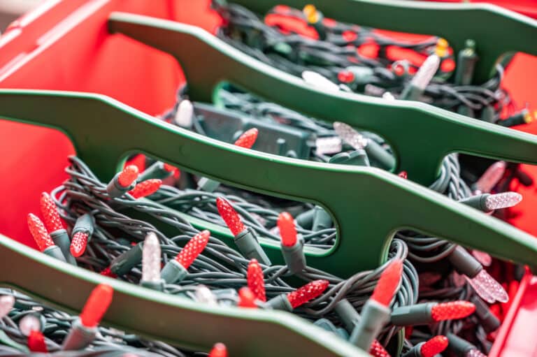 Rows of christmas light strings in an organizer tub